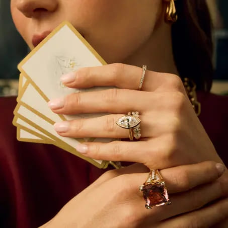 close up of woman wearing gemstone rings